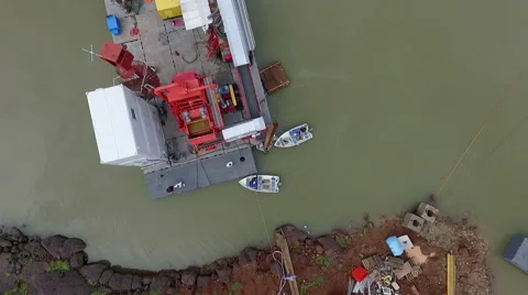The drone over a platform to extract gold in Africa, on a lake. Vertical aerial Stock Footage 67413046