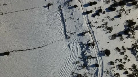 Drone over plow marks in the snow Stock Footage 196289026