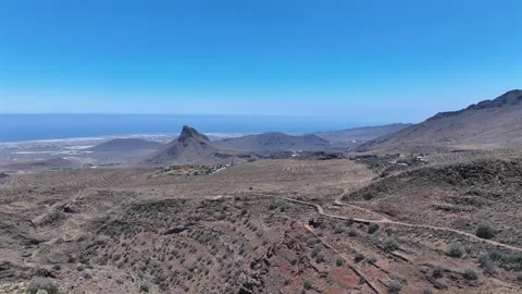 Drone over raw mountain terrain with distant peaks and Atlantic horizon Stock Footage 310683318