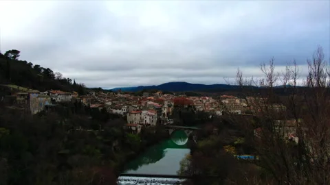 Drone over river between trees toward village Stock Footage 347585339
