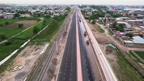 A drone over a section of the citys asphalt road during repairs. Sunny summer Stock Footage 310302549