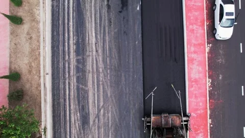 A drone over a section of the citys asphalt road during repairs. Sunny summer Stock Footage 311805700