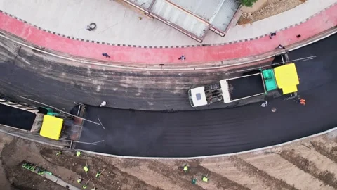 A drone over a section of the city's asphalt road during repairs. Sunny summer Stock Footage 335461356