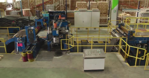A drone over a sheet metal processing conveyor belt in a large workshop. Stock Footage 271077072