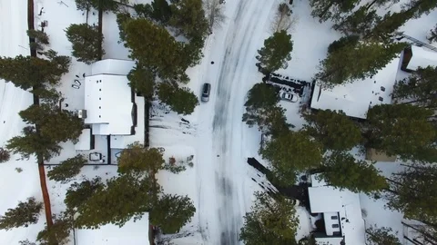 Drone Over Snowy City with Trees Stock Footage