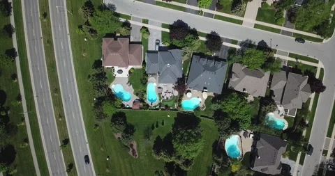 Drone Over Suburbs with Pools Stock Footage 141979459