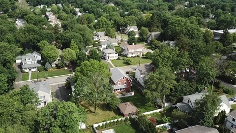Drone over summer town trees and houses 스톡 동영상 111400108