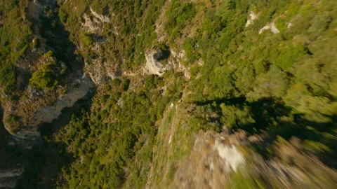 Drone Over Sunlit Landscape Towards Coastline And Sea Stock Footage 166867063