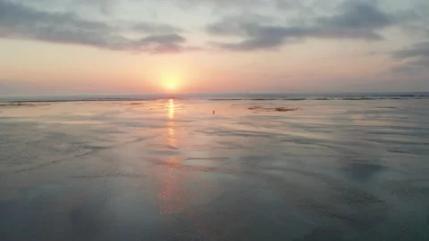 Drone Over Sunlit Sandy Beach At Low Tide Stock Footage 146102905