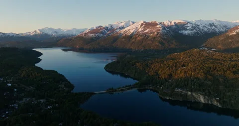 Drone Over Sunlit Snow-capped Mountain Range And Forest Stock Footage 231245123