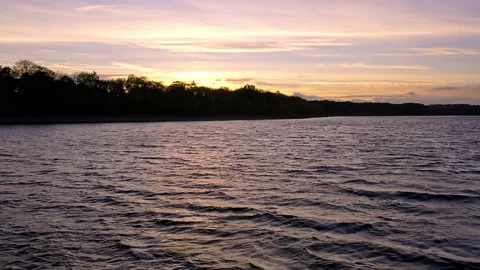Drone over sunset lake Stock Footage 220952010