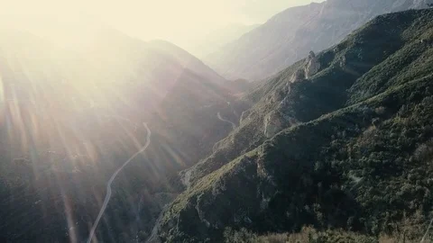 Drone over Taygetos Mountain and forest in Greece Sun Reflection Stock Footage 87534652
