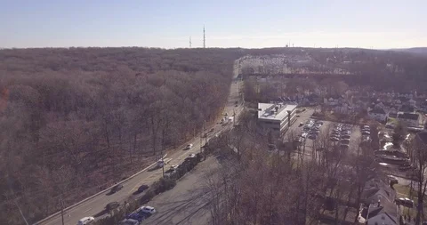 Drone over town freeway and forest wintertime Stock Footage 99583074
