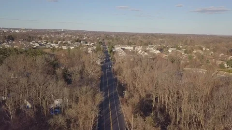 Drone over town rode between trees 動画素材 104803247