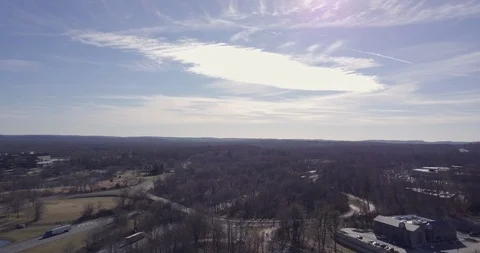 Drone over town trees horizon sun flare Video stock 101125233