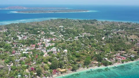 Drone over the trees of Gili Trawangan with Gili Meno and Air beyond Stock Footage 344986408
