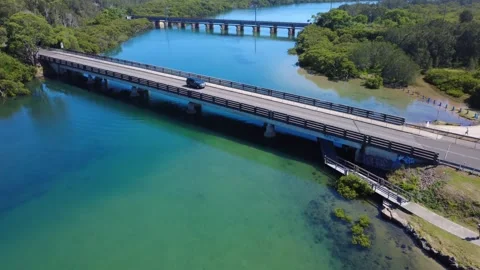 Drone Over Vibrant Blue River with Bridges and Swimmers Stock Footage 331606722