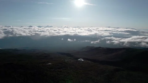 Drone Over Volcanic Mountains and Lodge Above Clouds, La Réunion, High Contrast Stock Footage 315372528