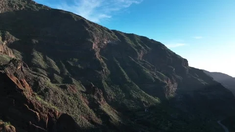 Drone Over Volcanic Mountainside with Clear Blue Sky Stock Footage 309949136