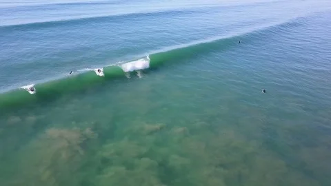 Drone over wave as surfer drops in on wave Stock Footage 71133928