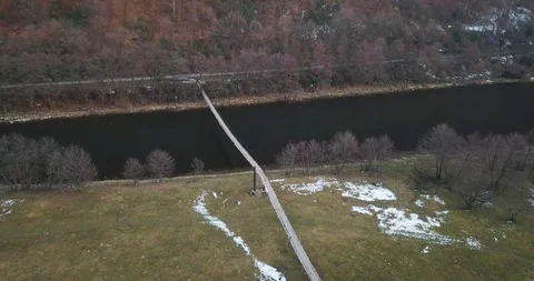 Drone over winter river suspension bridge 4k Stock Footage 123614006