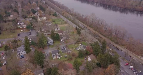 Drone over winter town next to river 스톡 동영상 98841459