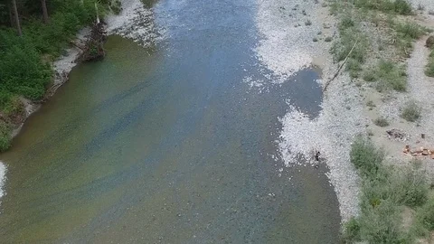 Drone Overhead Man walking along River  Stock Footage 92174542