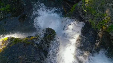 Drone overhead shot flies up over waterfall Stock Footage 318476953