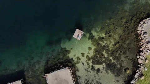 Drone overhead view of a boy jumping into the sea from a small raft Video stock 273250960