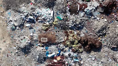 Drone overhead view of open dump site debris and rubble Vidéo 329353073