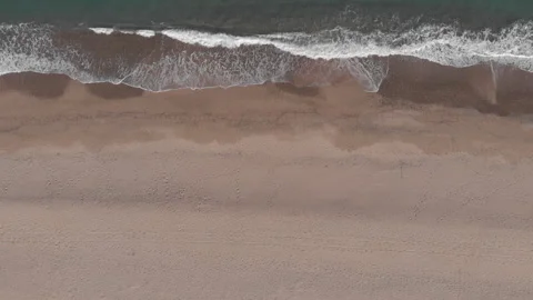 Drone Overhead View of Waves Crashing on Sandy Beach Stock Footage 298007513