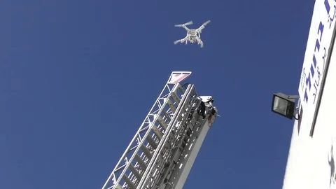 A drone oversees the activity of firefighters on a crane Stockbeeldmateriaal 72019091