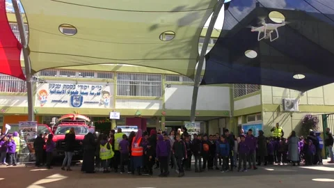 A drone oversees activity in school yard during drill Видео 135359546