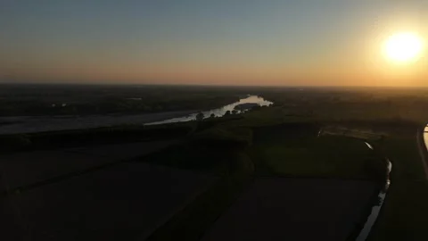 Drone pan above Po River and farmland at sunset near Spinadesco, Cremona, Italy Stock Footage 340604169