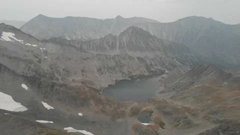 Drone pan across rugged mountain range in wildfire smoke Stock Footage 166754469