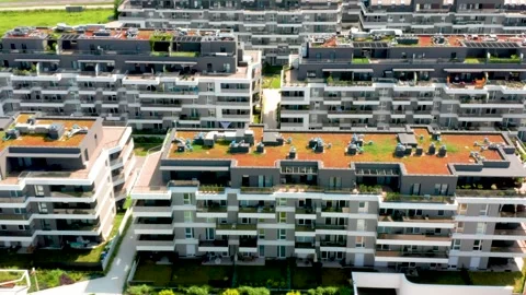 Drone pan and tilt tracking over modern grey and white apartment complex Stock Footage 312593393