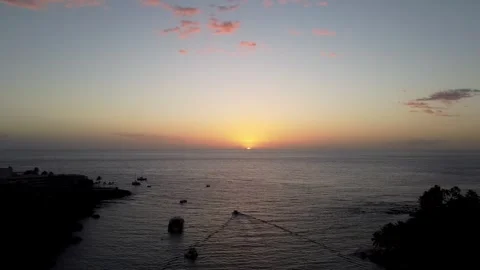 Drone pan of bayliner going out to sea at sunset in Kauai Stock Footage 260587006