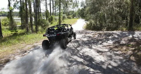 Drone Pan of Can-am ATV Kicking Sand in Forested Area in Florida Vídeo Stock 209591583