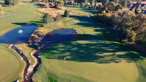 Drone pan course over pond to multiple fairways Stock-Footage 105643172