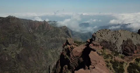 Drone pan down over mountaintop revealing valleys below Madeira Stock Footage 140623266