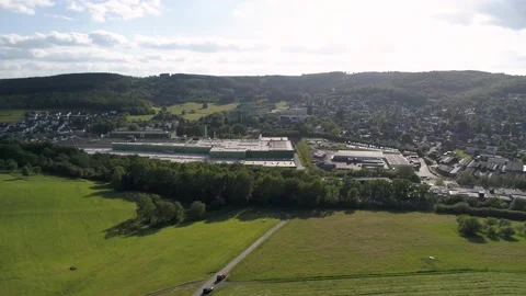 Drone pan of an industrial area with fields next to it Stock Footage 133417396