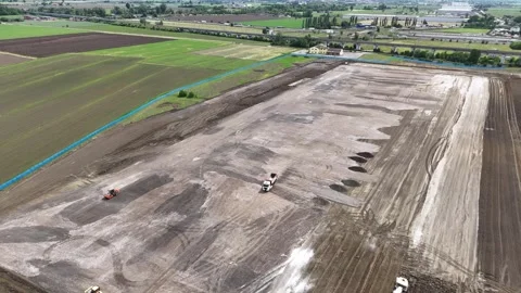 Drone pan left above logistics park construction site near Fiorenzuola d'Arda Stock Footage 336257263