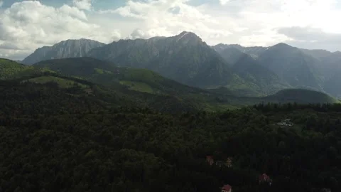 Drone pan of mountain skyline with light clouds Stock Footage 297254592