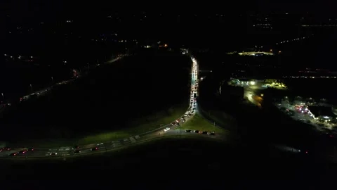 Drone pan night view of harlow M11 Essex UK roundabout in rush hour Stock Footage 166919042