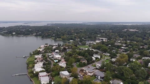 Drone pan over Great Neck homes and a sheltered inlet Video stock 347924933