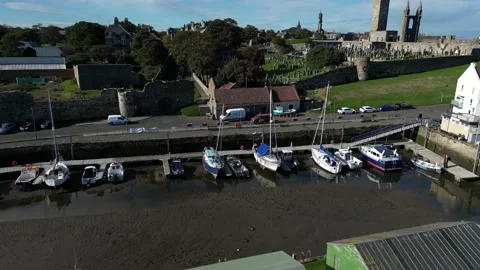Drone pan over St Andrews harbour and boats Stock Footage 219024203