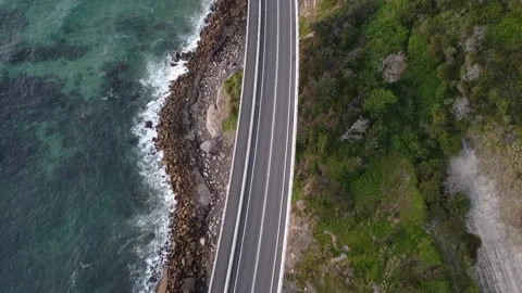 Drone pan shot of a bridge and waves at sea cliff bridge Stock Footage 143620464