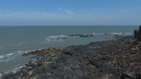 Drone pan shot of fort wall of a sea fortress by a rocky cliff Stock Footage 117333300