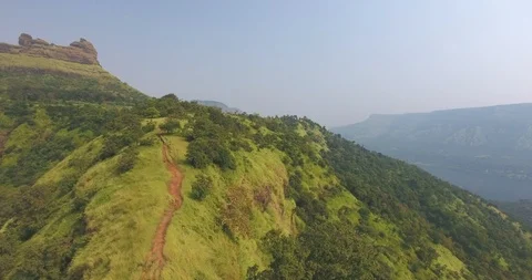 Drone pan shot of lakes, mountain ranges and lush green forests Stock Footage 117582151