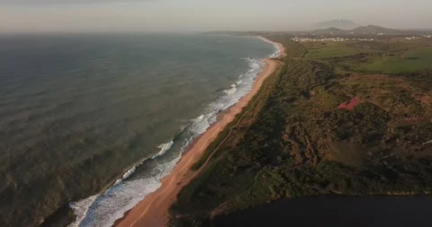 Drone pan shot of Macaé cityscape with ocean and Imboassica Lagoon Stock Footage 317731351
